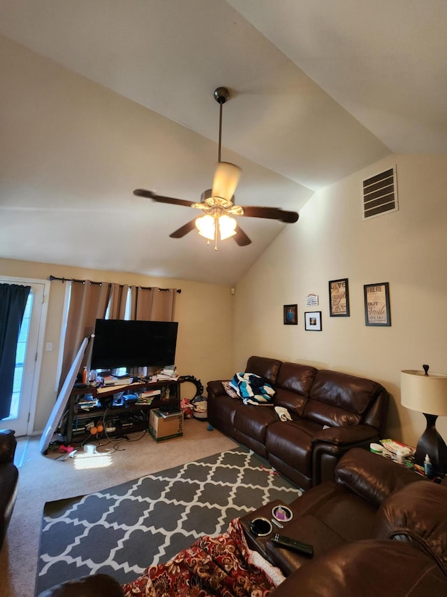 living room featuring lofted ceiling, ceiling fan, and carpet