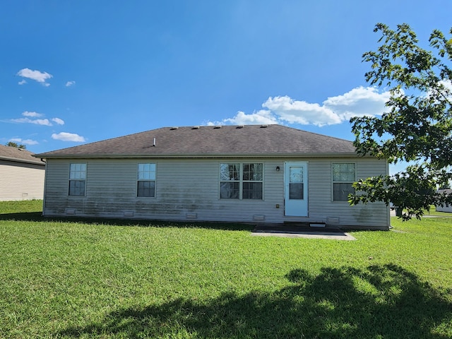 rear view of house with a patio and a yard