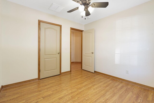 empty room featuring light wood-style floors, baseboards, and a ceiling fan