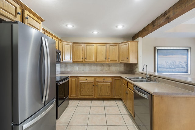 kitchen with light tile patterned floors, appliances with stainless steel finishes, a sink, and tasteful backsplash