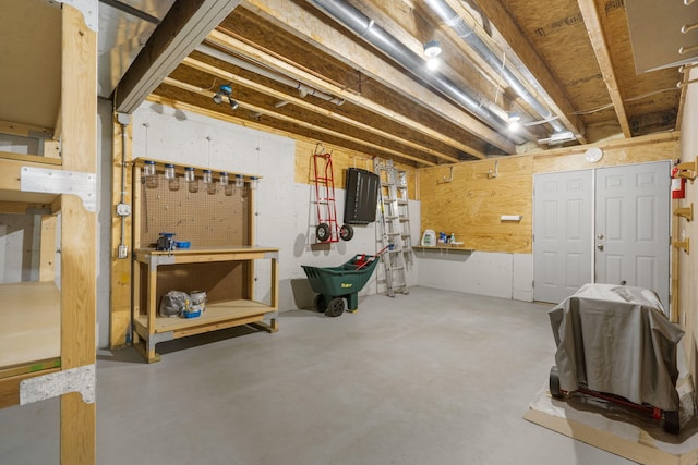 unfinished basement featuring a workshop area