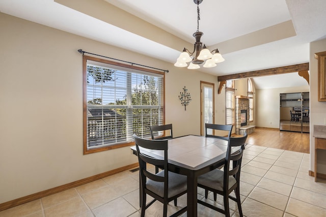 dining room with light tile patterned floors, beam ceiling, baseboards, and a notable chandelier