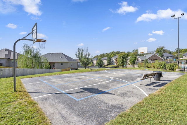 view of sport court featuring community basketball court, a residential view, and a lawn