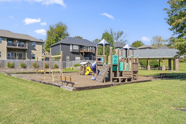 communal playground with a yard and fence