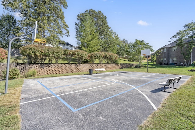 view of sport court featuring a yard, community basketball court, and fence