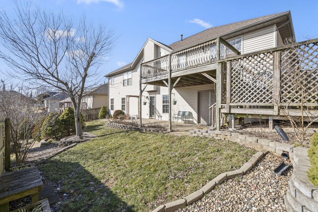 back of property featuring a patio, a lawn, a wooden deck, and fence