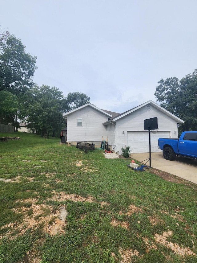 view of side of property with a garage and a yard