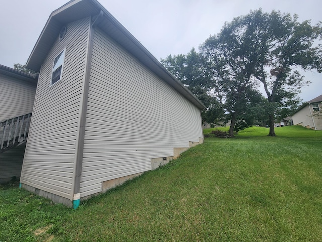 view of side of property with a yard