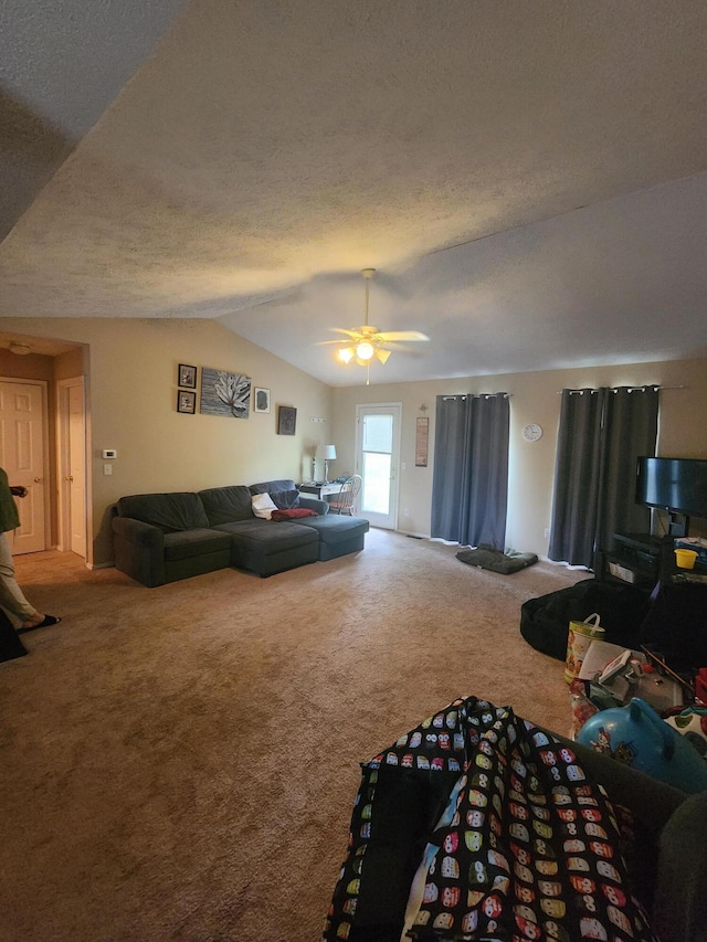 carpeted living room with lofted ceiling, a textured ceiling, and ceiling fan