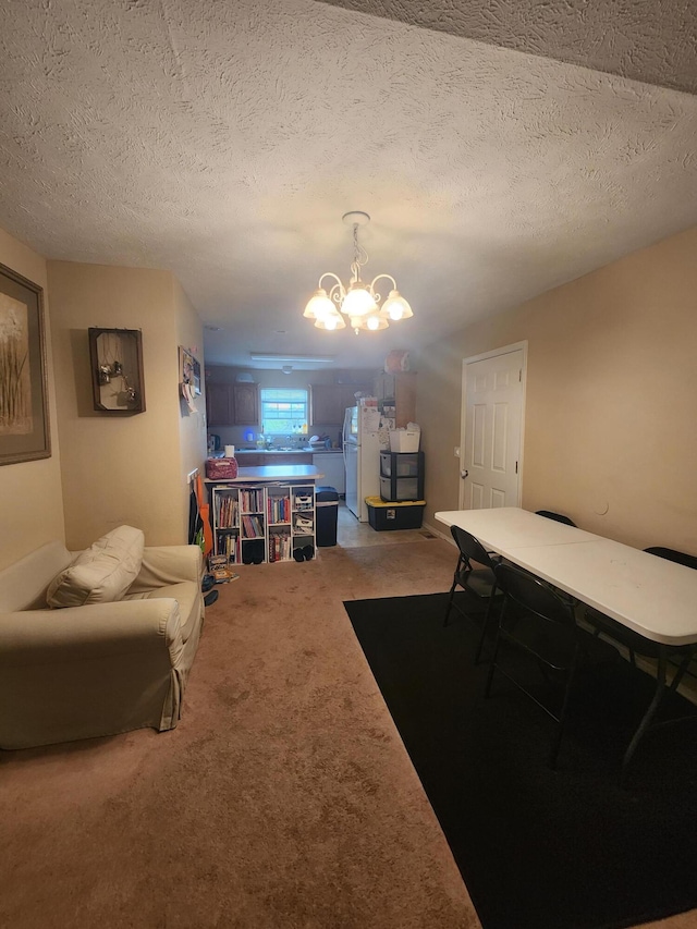 interior space featuring a notable chandelier, carpet floors, and a textured ceiling