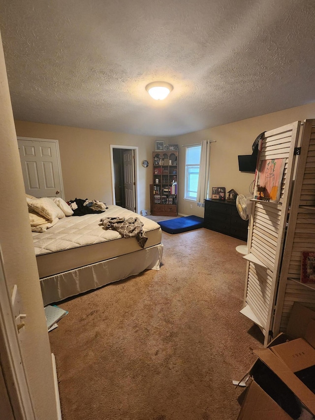 carpeted bedroom with a textured ceiling