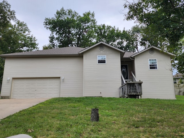 view of front of house with a front yard and a garage