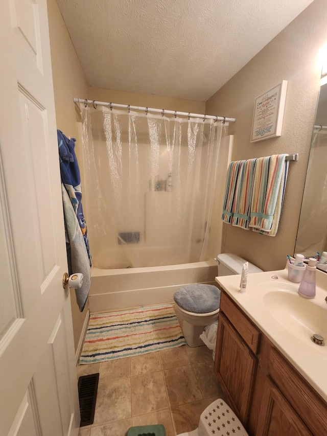 full bathroom with shower / bath combo, toilet, vanity, and a textured ceiling