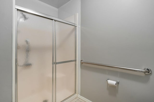 bathroom with a shower with door