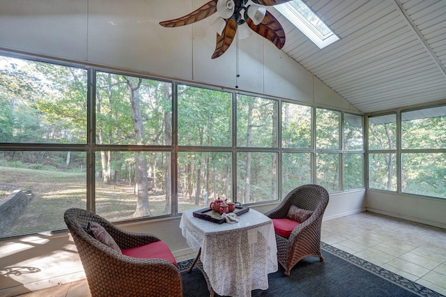 sunroom / solarium featuring ceiling fan, plenty of natural light, and vaulted ceiling with skylight