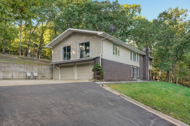 view of home's exterior with a garage and a yard