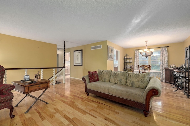 5920 State Highway A, Strafford, MO 65757 - living area with a chandelier, light wood-type flooring, and a textured ceiling
