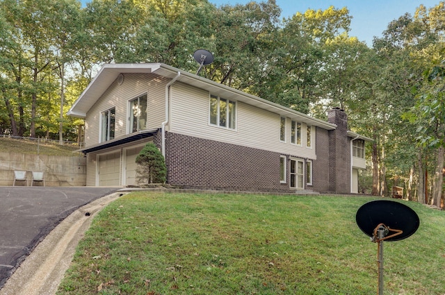 view of side of property with a garage and a lawn