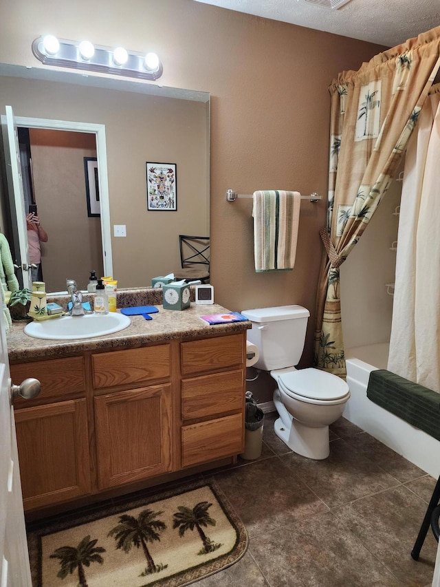 full bathroom featuring vanity, a textured ceiling, tile patterned floors, toilet, and shower / tub combo with curtain