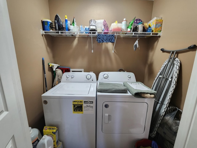 clothes washing area with washer and clothes dryer