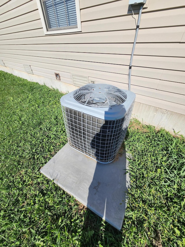 exterior details featuring wood walls and central AC unit