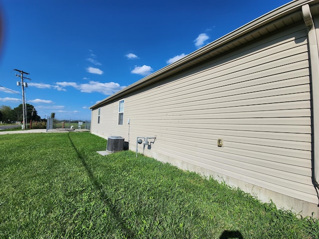 view of home's exterior featuring a yard and central air condition unit