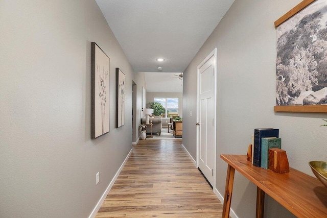 corridor with light hardwood / wood-style flooring