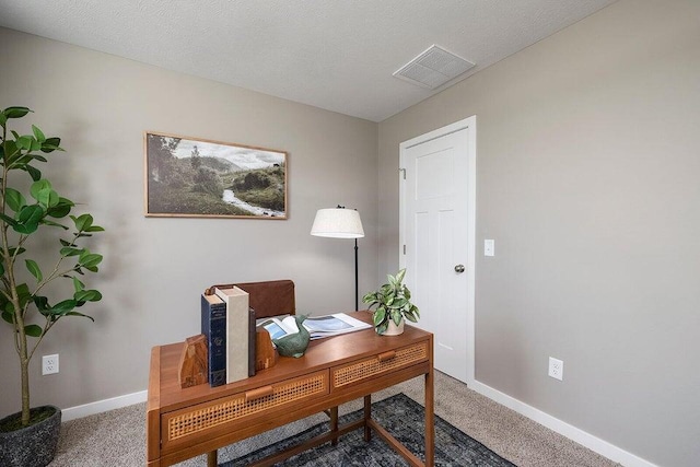 office featuring carpet floors and a textured ceiling