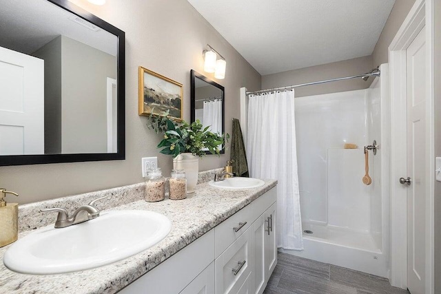 bathroom with walk in shower and vanity