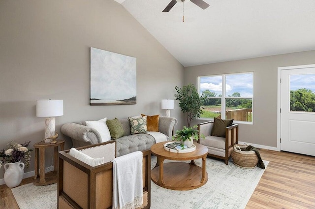 living room featuring lofted ceiling, light hardwood / wood-style floors, and ceiling fan