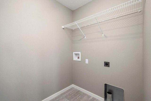 washroom with washer hookup, hookup for an electric dryer, and wood-type flooring