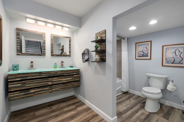 full bathroom featuring vanity, toilet, hardwood / wood-style floors, and shower / bath combo