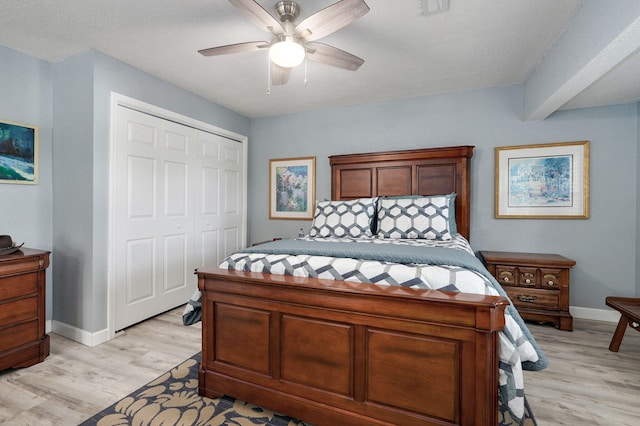 bedroom with a closet, ceiling fan, and light hardwood / wood-style flooring