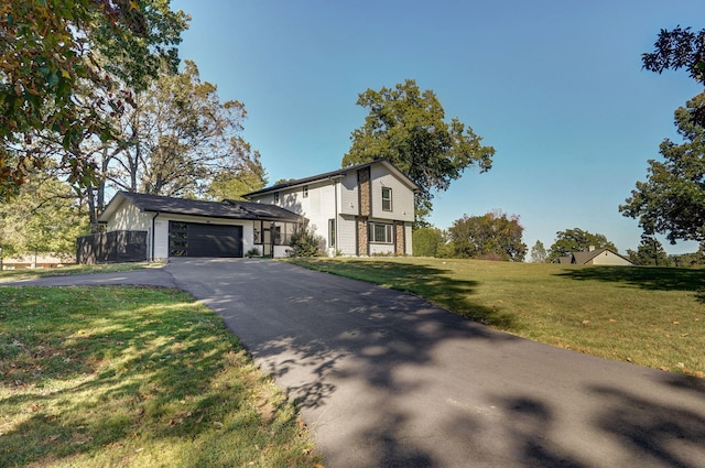 view of front of home featuring a garage and a front yard