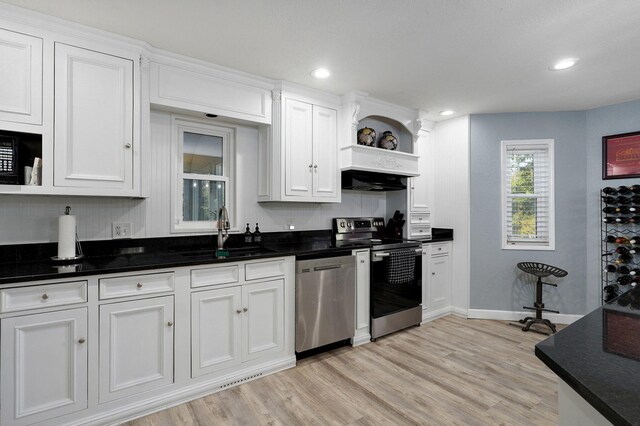 kitchen featuring stainless steel appliances, light hardwood / wood-style floors, sink, and white cabinets