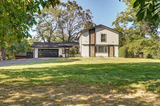 view of front of home with a garage and a front lawn