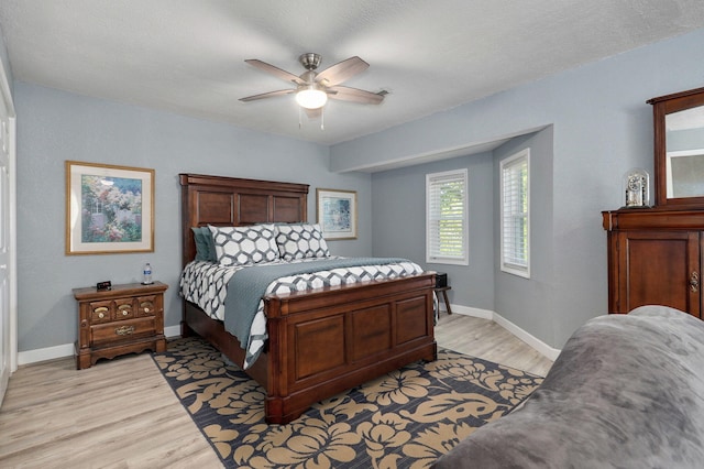 bedroom with ceiling fan and light hardwood / wood-style flooring