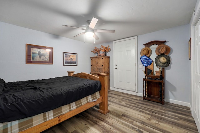 bedroom with hardwood / wood-style flooring and ceiling fan