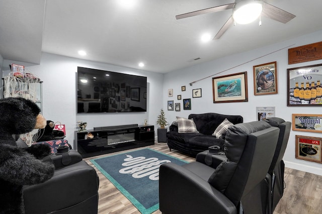 living room with ceiling fan and hardwood / wood-style floors