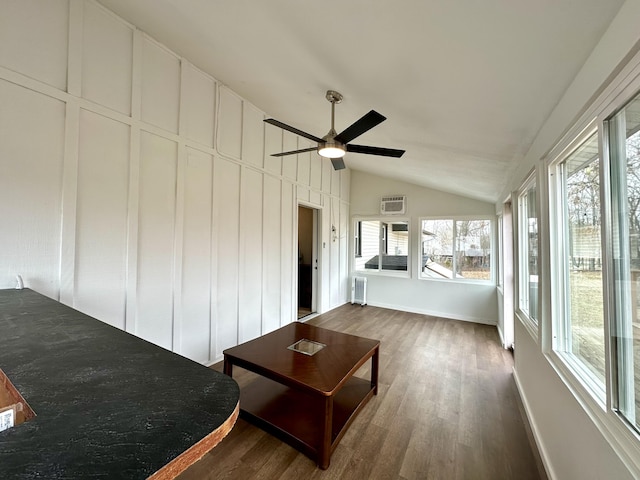 unfurnished sunroom featuring radiator heating unit, vaulted ceiling, and ceiling fan