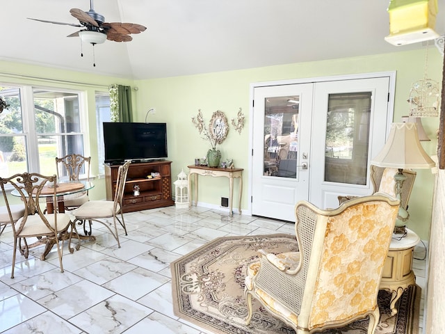 living room featuring ceiling fan and vaulted ceiling