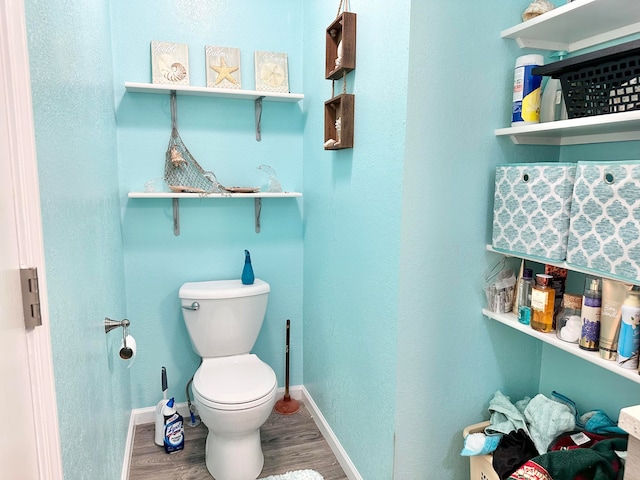 bathroom featuring hardwood / wood-style flooring and toilet