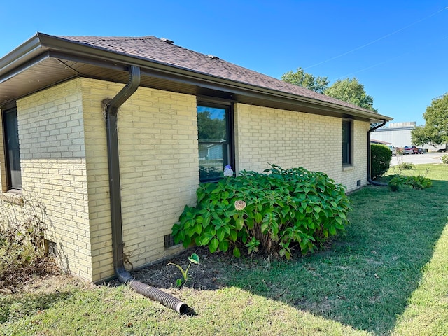 view of home's exterior with a yard