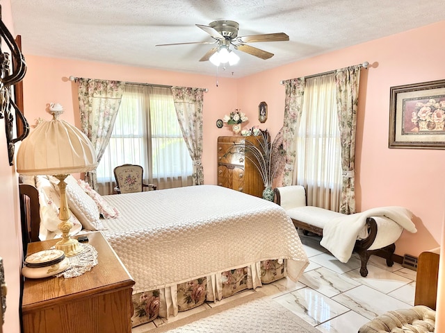 bedroom featuring a textured ceiling and ceiling fan