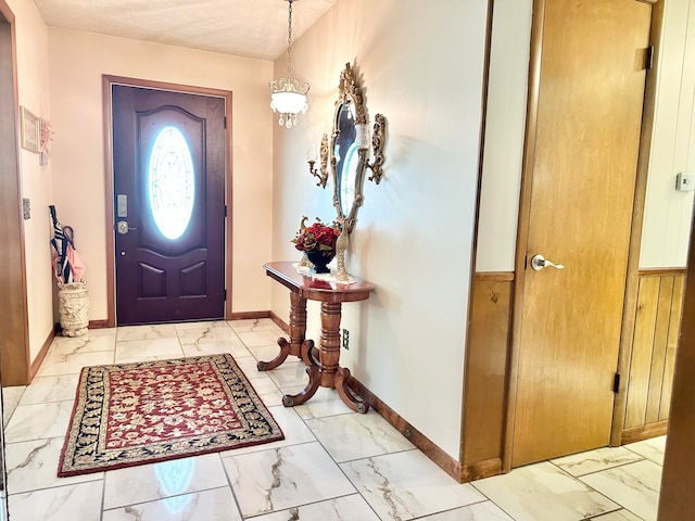 entryway featuring wood walls and a textured ceiling