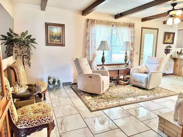 sitting room with a textured ceiling, beamed ceiling, and ceiling fan