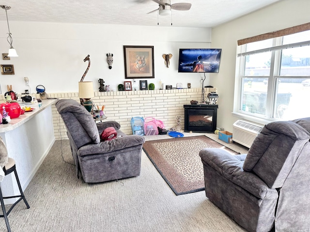 carpeted living room featuring a fireplace, a textured ceiling, ceiling fan, and an AC wall unit