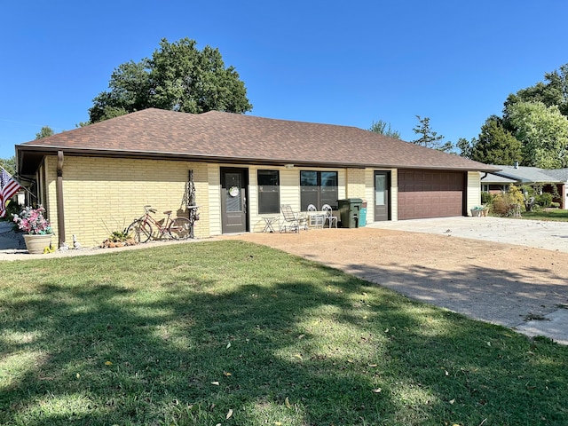 single story home featuring a garage and a front lawn