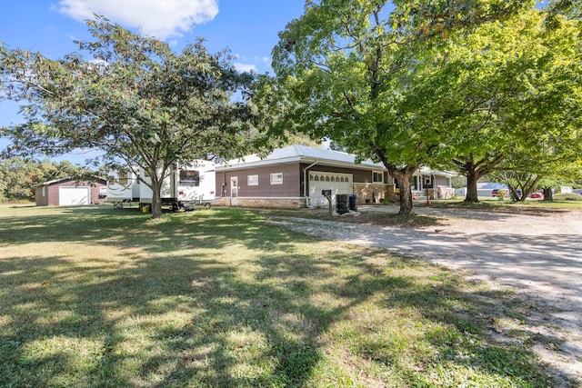 view of front facade with an outbuilding and a front lawn