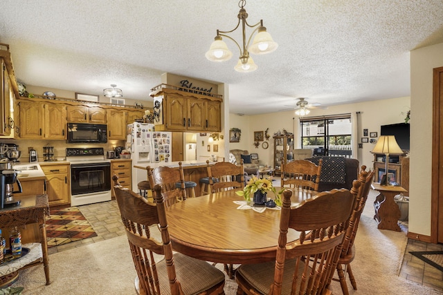 dining room with ceiling fan with notable chandelier, light colored carpet, and a textured ceiling